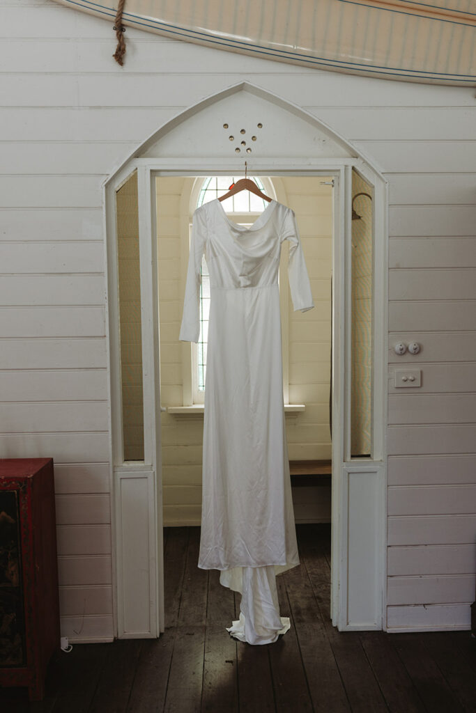 wedding dress hanged on the door