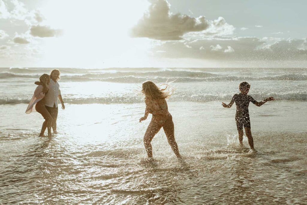 A family splashing and having fun at the beach